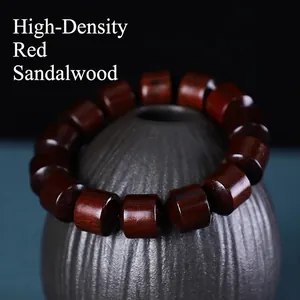 Macro shot of high-density sandalwood cylinder beads with deep reddish-brown texture