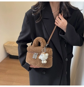 Brown faux shearling crossbody bag with cute white puppy pendant detail on strap