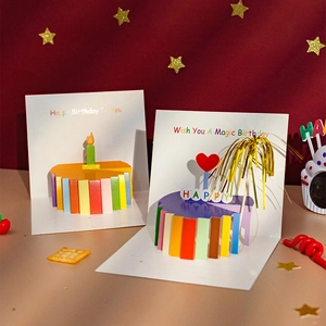 3D pop-up birthday cards with rainbow cakes and candles on festive warm background
