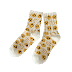 White cotton mid-calf socks with yellow cartoon smiley face and SMILE print design