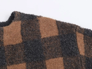 Close-up of brown and grey checkered knit coat showing soft mohair texture and collar detail