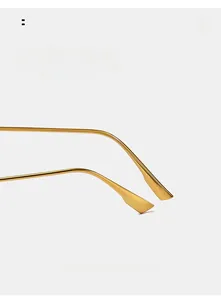 Close-up of golden curved metal temples for vintage oval sunglasses with smooth finish