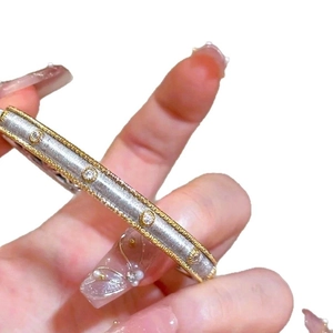 18K gold plated two-tone cuff bangle with milgrain edges and sparkling cubic zirconia