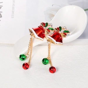 Christmas bell tassel brooch with red crystals and bow in a decorative white spoon