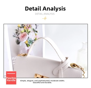 Detail shot of white litchi pattern leather handbag with gold metal clasp and chain