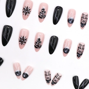 Christmas almond press-on nails featuring black and pink reindeer and snowflake art
