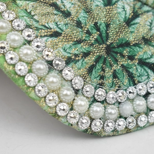 Macro shot of baseball cap edge with sparkling rhinestones, pearls and floral embroidery