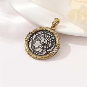 Macro detail of a vintage Greco-Roman coin pendant with zircons on white silk background