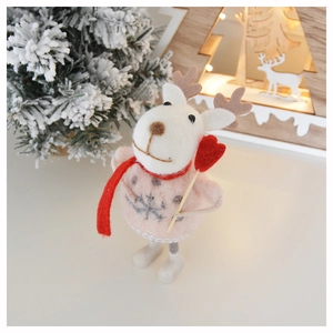 Close-up of handmade wool felt reindeer decoration with pink sweater and red heart