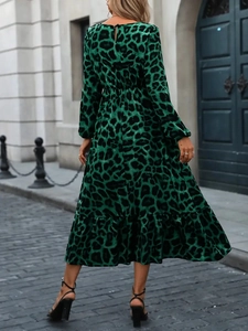 Rear view of green leopard print maxi dress with elastic waist and ruffled hem details