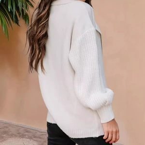 Side view of white knitted cardigan with thick stitched sleeves and classic notched lapel
