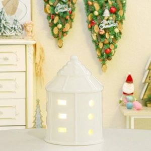Nordic white ceramic house lantern with hollow design and LED warm light decoration