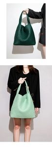 Detail of woven texture and leather handle on a green handmade oversized tote bag