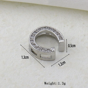 Detailed view of micro-paved zircon earring with size dimensions 1.3cm by 1.2cm