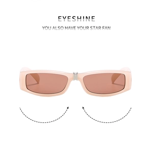 Detail of pink folding sunglasses featuring metal hinges and functional storage design