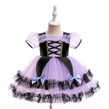 Detail of girls witch pumpkin dress with purple mesh tutu skirt and bow accents