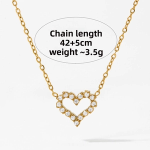 Detailed view of heart-shaped gold necklace with sparkling cubic zirconia inlay