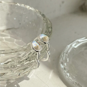 Minimalist 925 silver hoop earrings with iridescent teardrop stones on glass