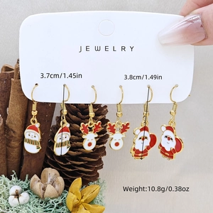 Detail view of snowman, reindeer, and Santa earrings set with size and weight specs