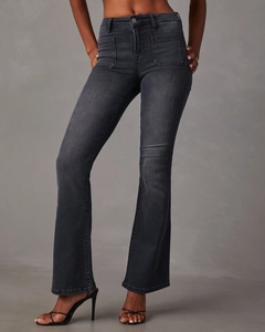 Detail of high-waist flared jeans in dark grey featuring front patch pockets and slim fit