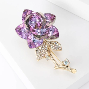 Detail shot of purple crystal rose brooch with gold-plated stem and shimmering petals