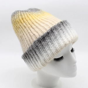 Detail of ribbed knit texture on a gradient beanie with yellow and grey wool blend