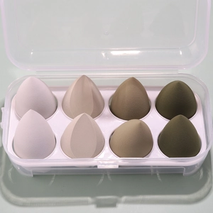 Detailed view of 8 soft makeup sponges in a neat storage box with white slots