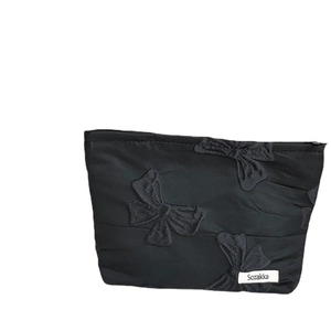 Elegant black cosmetic bag with 3D ribbon embroidery and minimalist brand label