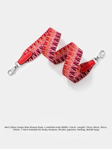 Detail of woven replacement shoulder strap with red leather ends and silver swivel clasps