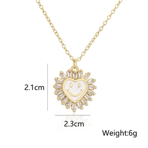 Macro shot of 2.1x2.3cm gold heart smiley pendant with cubic zirconia and 6g weight