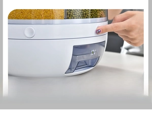 Macro view of rotating dry food dispenser with one-click dispensing button and storage drawers