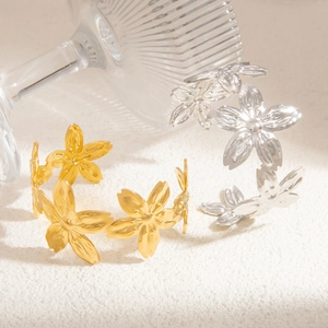Detailed view of 3D cherry blossom floral open bangles in polished gold and silver finishes