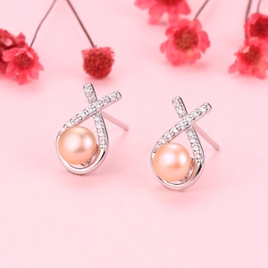Elegant natural pink pearl earrings with silver criss-cross design and crystal accents