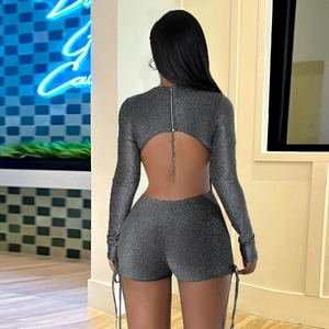 Detail of dark grey sequin bodysuit showing the large open back and adjustable side drawstrings