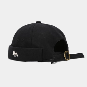 Detail of fox embroidery on black canvas docker hat with adjustable brass buckle