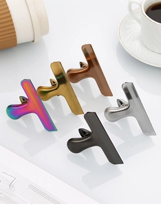 Set of five elegant metal hair claw clips in various metallic finishes on white background