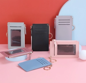 Close-up of thin leather card holder featuring multiple slots and metal zipper pocket