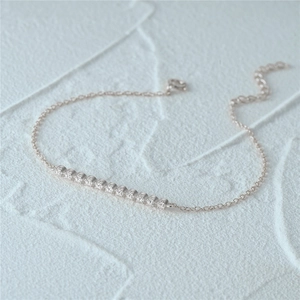 Macro shot of silver S925 sterling silver chain with a row of small zircon stones
