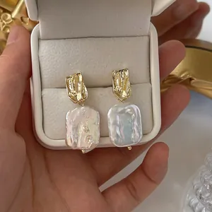 Baroque freshwater pearl earrings with pleated gold metal accents in a vintage box