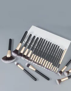 Detailed 45-degree view of 24 professional black and gold makeup brushes with synthetic hair