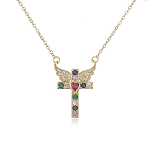 Macro shot of gold cross pendant with heart ruby and multicolored micro-pave crystals