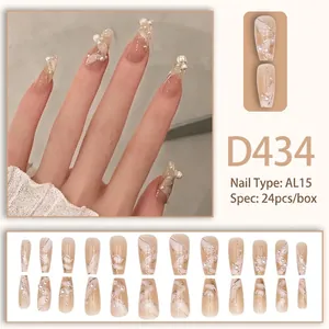 Detailed view of nude long coffin press-on nails with white 3D pearls and swirl textures