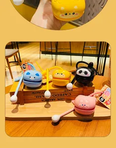 Detail of four colorful cartoon animal castanets with flexible handles and product tags