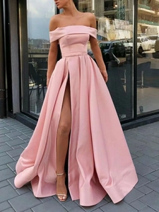 Detail view of pink satin off-shoulder evening gown with high leg slit and floor length
