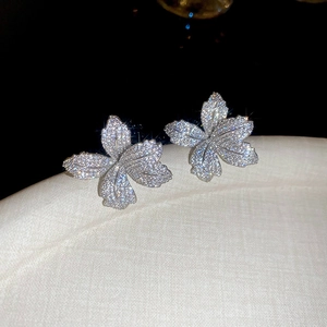 Macro shot of silver pavé crystal flower earrings with sparkling cubic zirconia stones