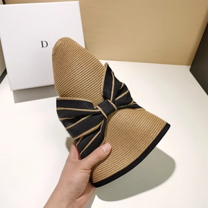 Foldable beige straw sun hat for women featuring an elegant large striped bow detail