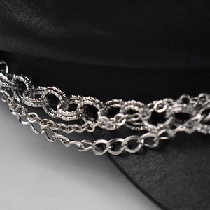 Detail of silver chain layers on black faux crocodile leather beret hat