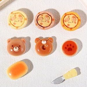 Flat lay of miniature resin animal bread figurines and cheese knife for DIY crafts