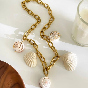 Chunky gold chain necklace with white seashells and spiral conch charms for women