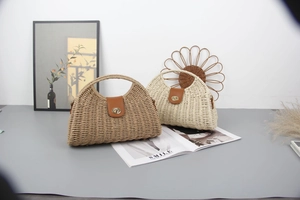 Detail of straw crescent bags with leather flap and golden twist lock in khaki and beige